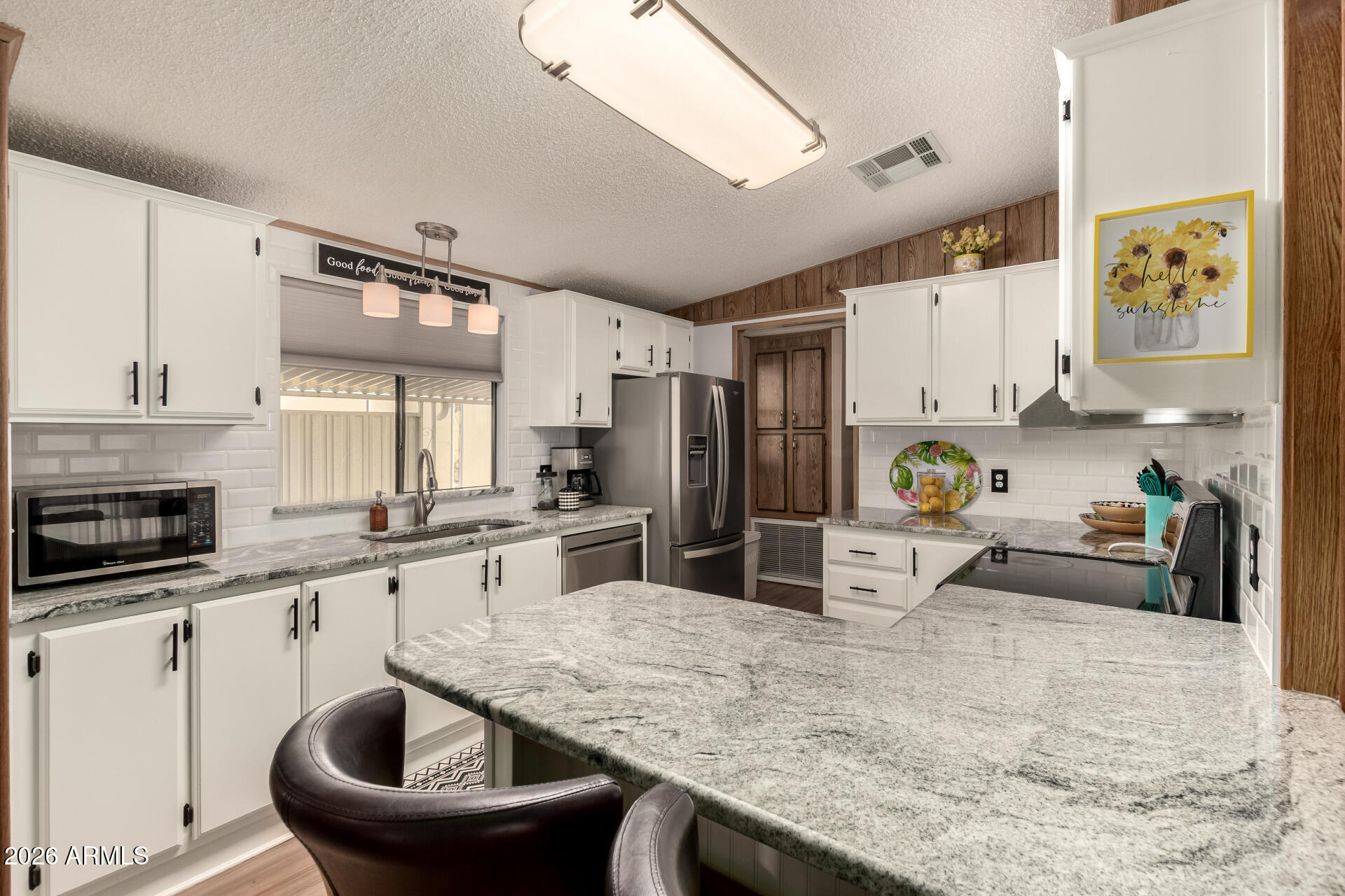 652 South Ellsworth Road, Unit 152 Mesa, AZ 85208 - Photo 15 of 30 a kitchen with granite countertop a sink stainless steel appliances and white cabinets