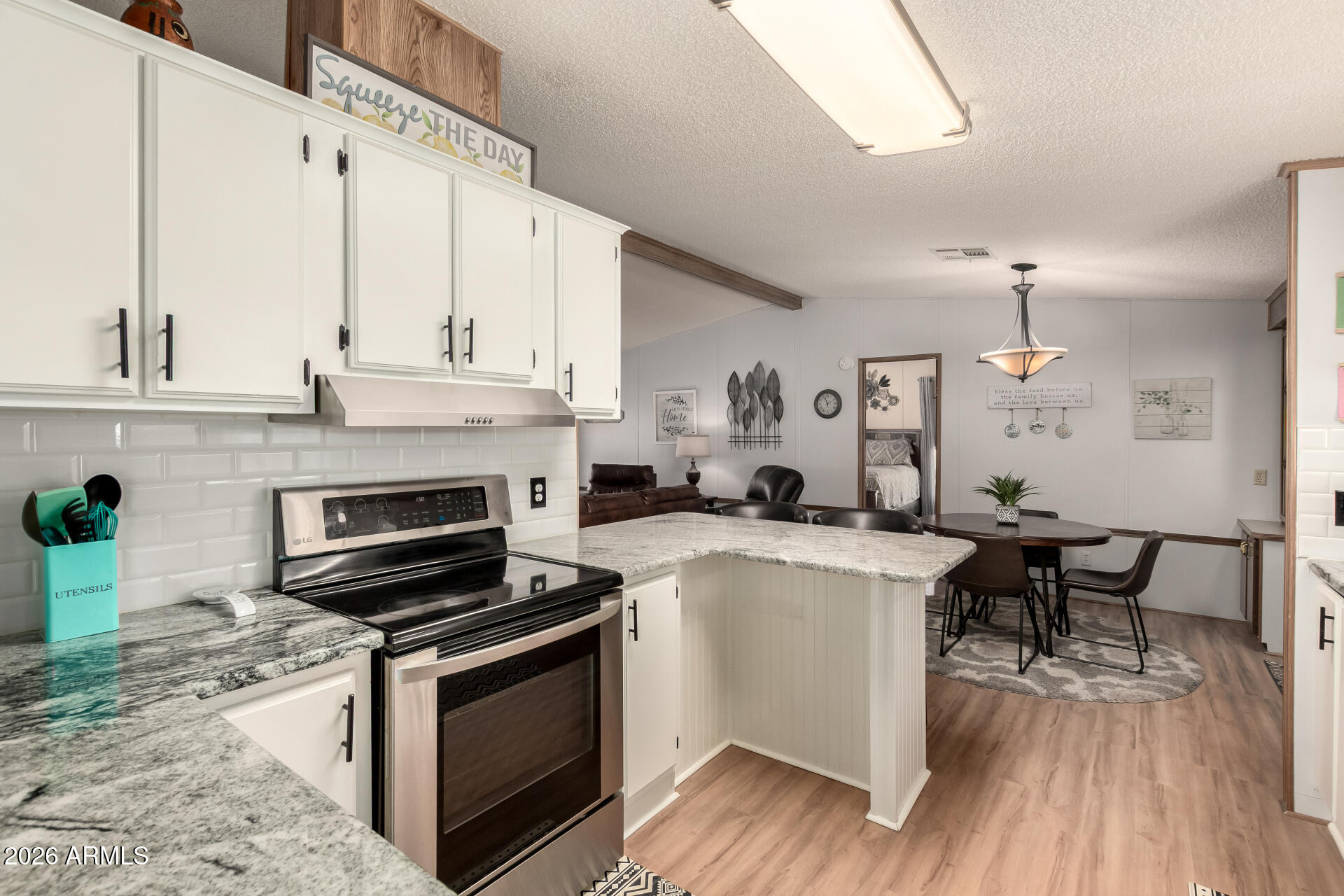 652 South Ellsworth Road, Unit 152 Mesa, AZ 85208 - Photo 16 of 30 a kitchen with a stove and a refrigerator
