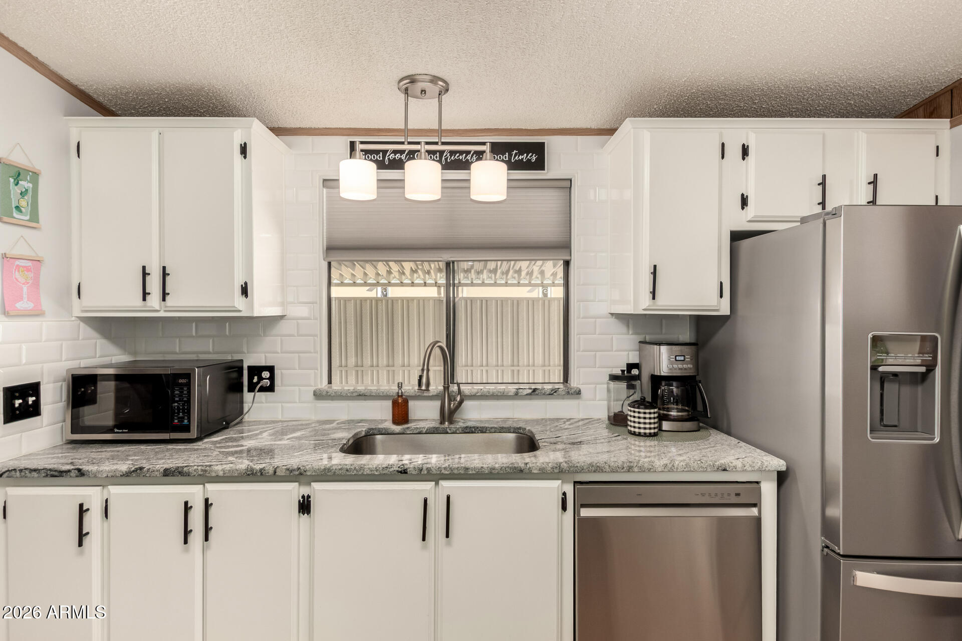 652 South Ellsworth Road, Unit 152 Mesa, AZ 85208 - Photo 17 of 30 a kitchen with stainless steel appliances granite countertop a kitchen island a stove a refrigerator and a sink
