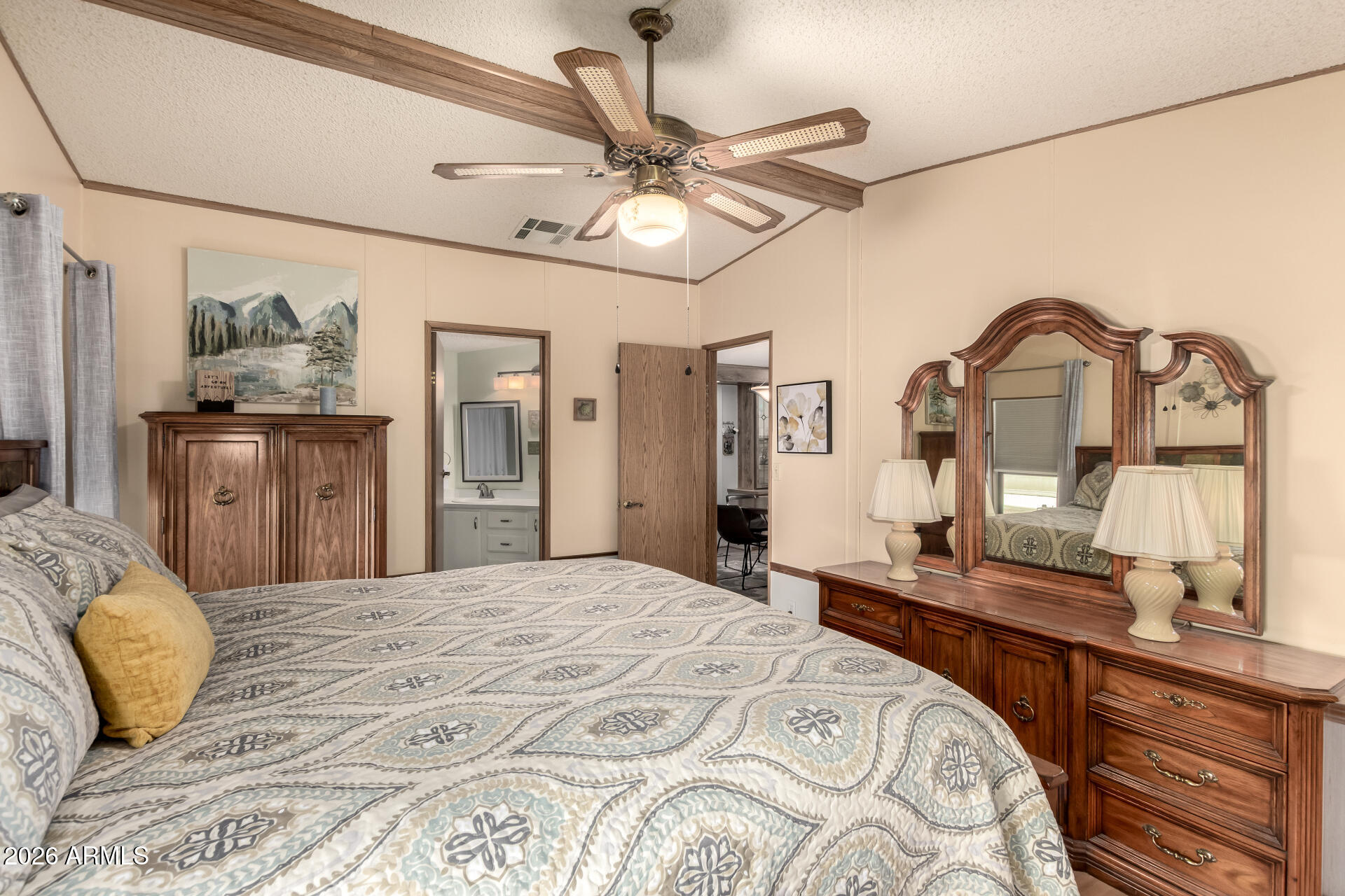652 South Ellsworth Road, Unit 152 Mesa, AZ 85208 - Photo 20 of 30 a bedroom with a bed and a chandelier
