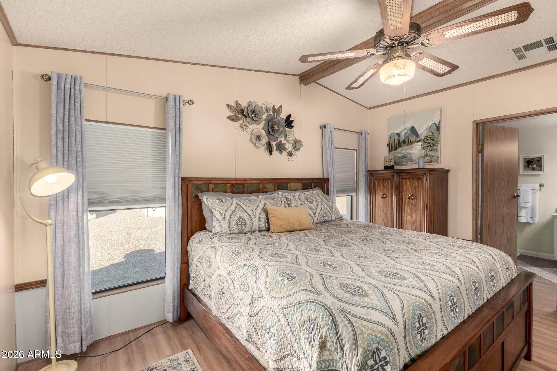 652 South Ellsworth Road, Unit 152 Mesa, AZ 85208 - Photo 21 of 30 a bedroom with a large bed and a chandelier