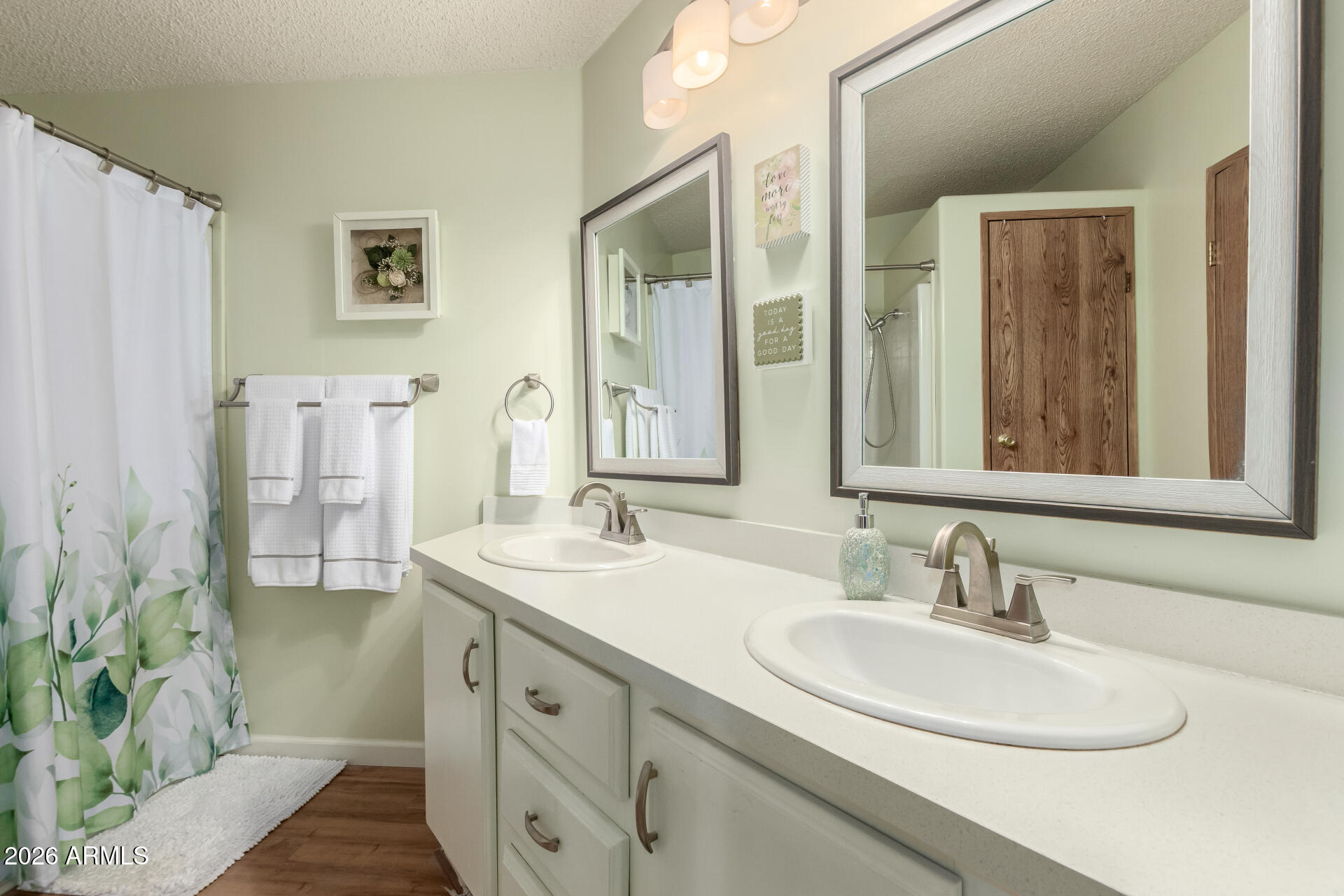 652 South Ellsworth Road, Unit 152 Mesa, AZ 85208 - Photo 22 of 30 a bathroom with a double vanity sink mirror and shower