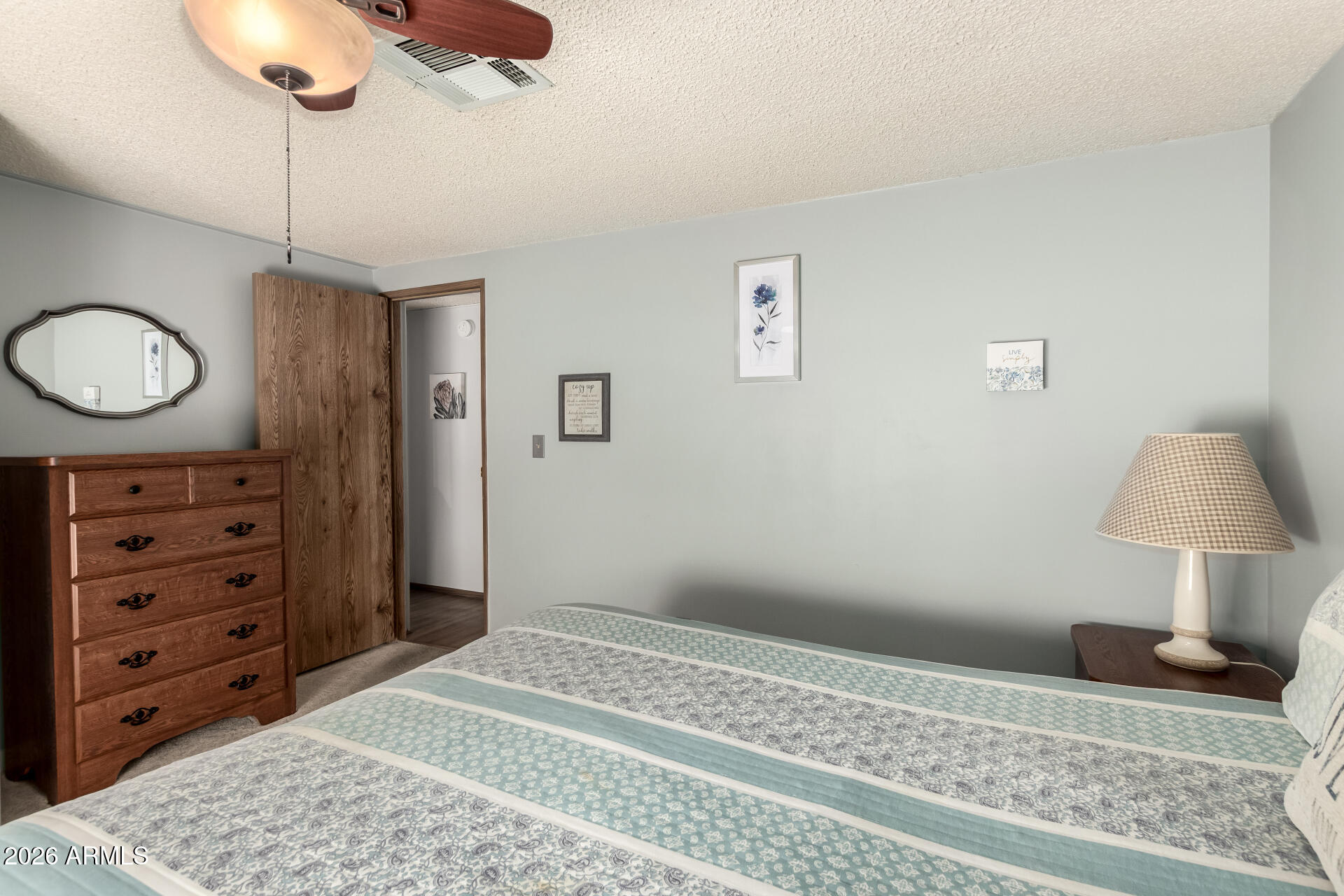 652 South Ellsworth Road, Unit 152 Mesa, AZ 85208 - Photo 26 of 30 a bedroom with a bed and a lamp on the dresser