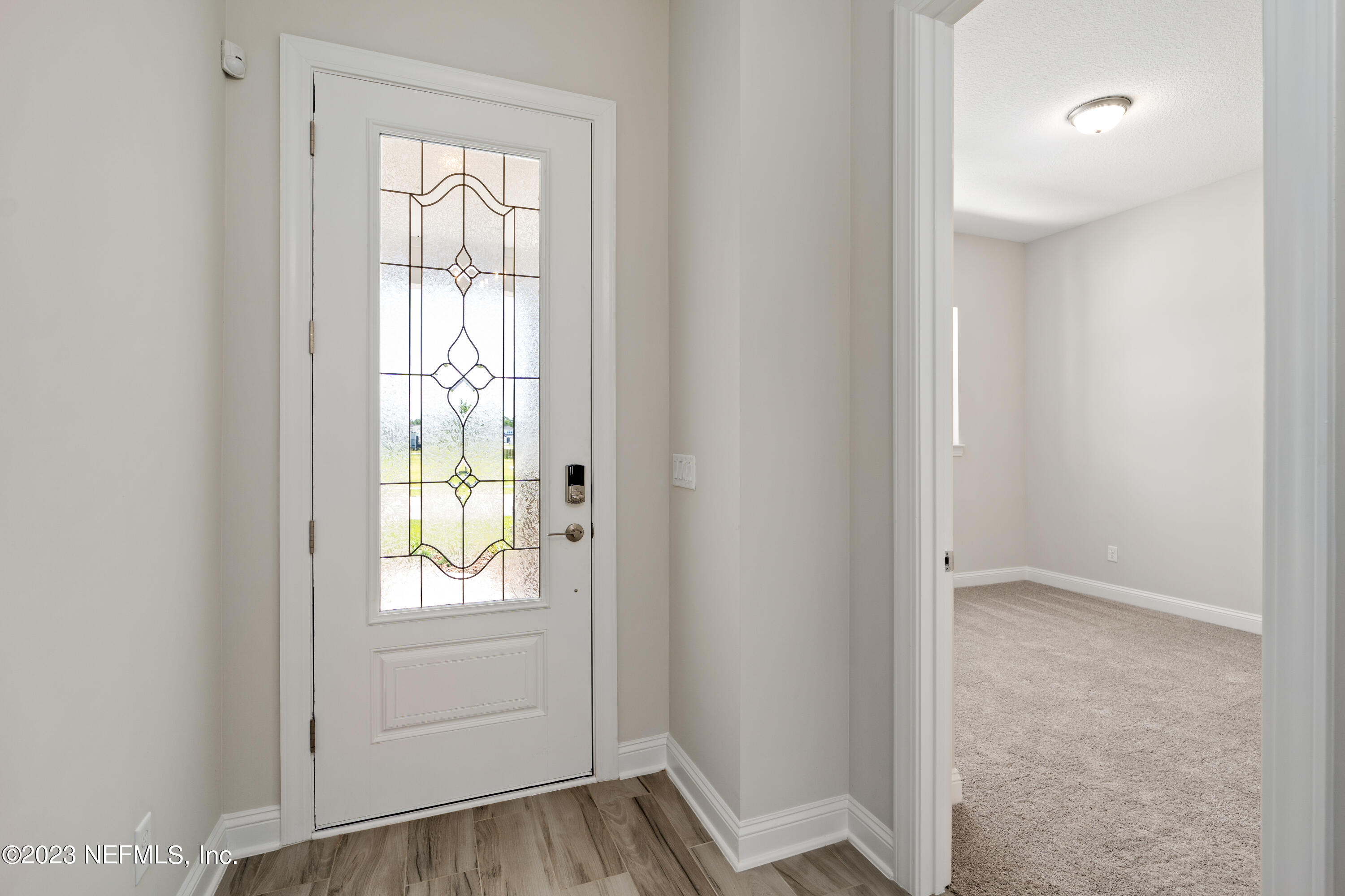 78 Clearview Drive St. Augustine, FL 32092 - Photo 20 of 61 a view of an empty room with wooden floor and a window