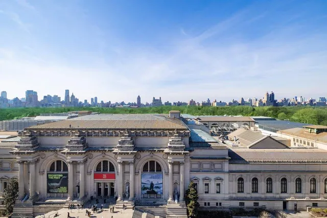 a view of a city that has tall buildings and a big yard