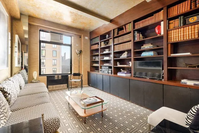 a dining room with furniture and a large window