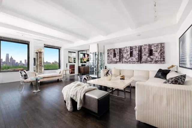 a living room with fireplace furniture and wooden floor