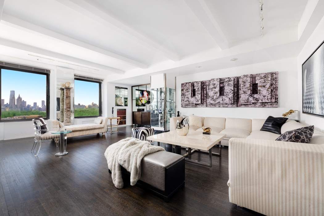 1010 5th Avenue, Unit 12F Manhattan, NY 10028 - Photo 4 of 17 a living room with furniture and a large window