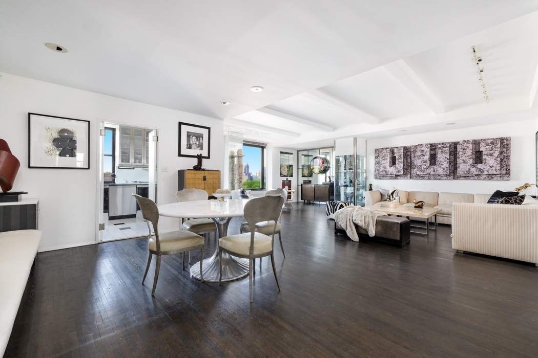 1010 5th Avenue, Unit 12F Manhattan, NY 10028 - Photo 5 of 17 a living room with furniture and a wooden floor