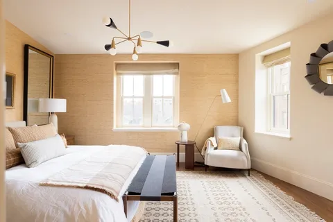 a bedroom with a bed couch and window