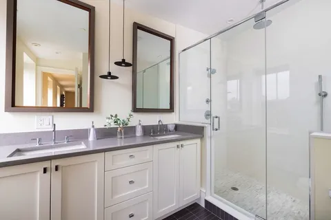 a bathroom with a double vanity sink mirror and double