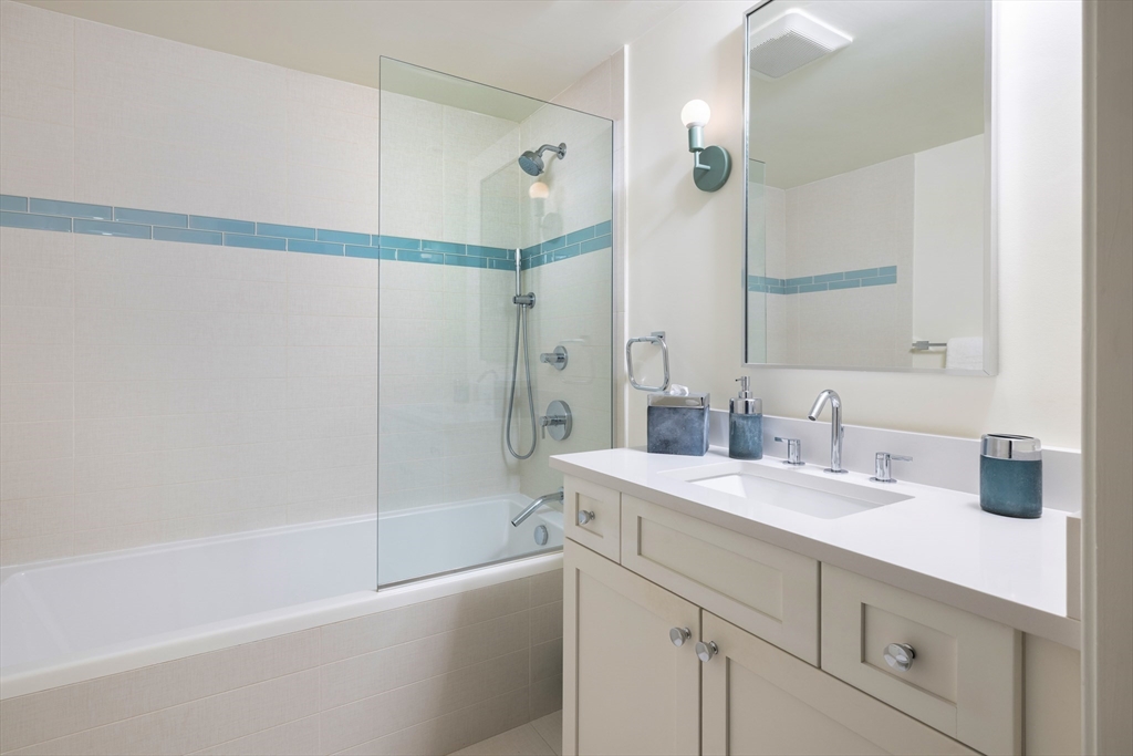 251 Shawmut Avenue, Unit 2 Boston, MA 02118 - Photo 20 of 21 a bathroom with a sink a mirror a bathtub and shower