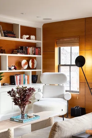a living room with furniture cabinets and a window