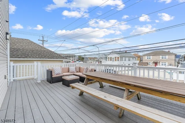 a roof deck with couch and chairs