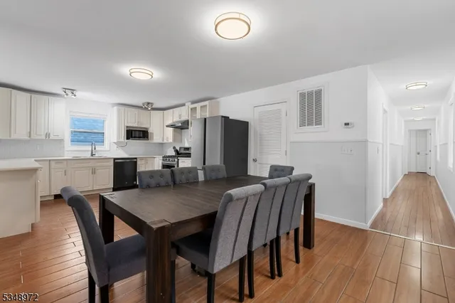a view of kitchen with cabinets table and chairs