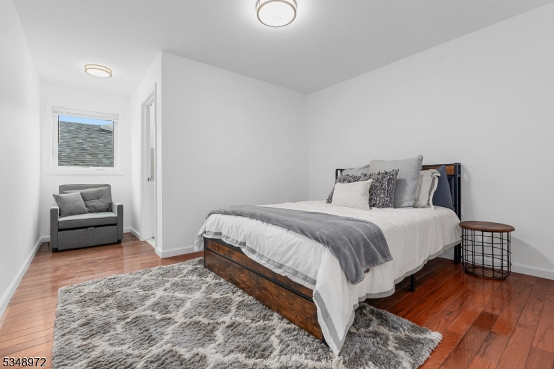 129 Franklin Avenue, Unit A Seaside Heights, NJ 08751 - Photo 6 of 14 a bedroom with a bed and a couch