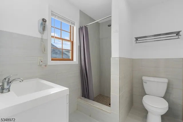 a bathroom with a toilet sink and shower