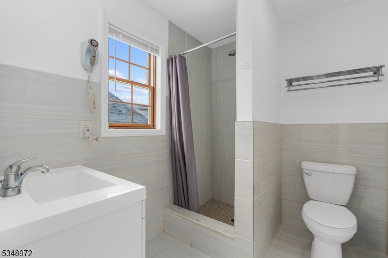 129 Franklin Avenue, Unit A Seaside Heights, NJ 08751 - Photo 7 of 14 a bathroom with a toilet sink and shower