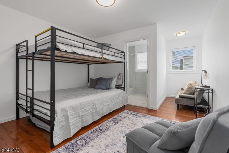 129 Franklin Avenue, Unit A Seaside Heights, NJ 08751 - Photo 8 of 14 a bedroom with a bed and a chandelier