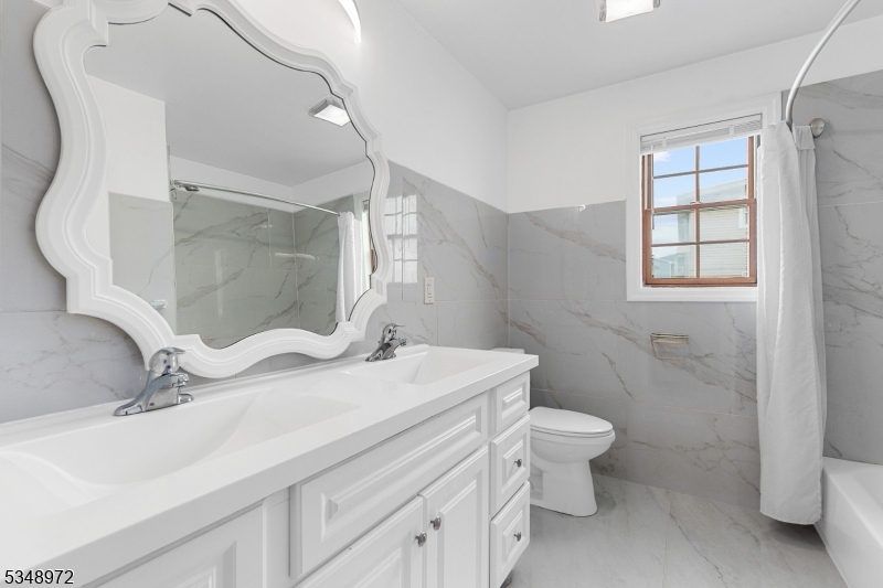129 Franklin Avenue, Unit A Seaside Heights, NJ 08751 - Photo 10 of 14 a bathroom with a sink toilet and mirror