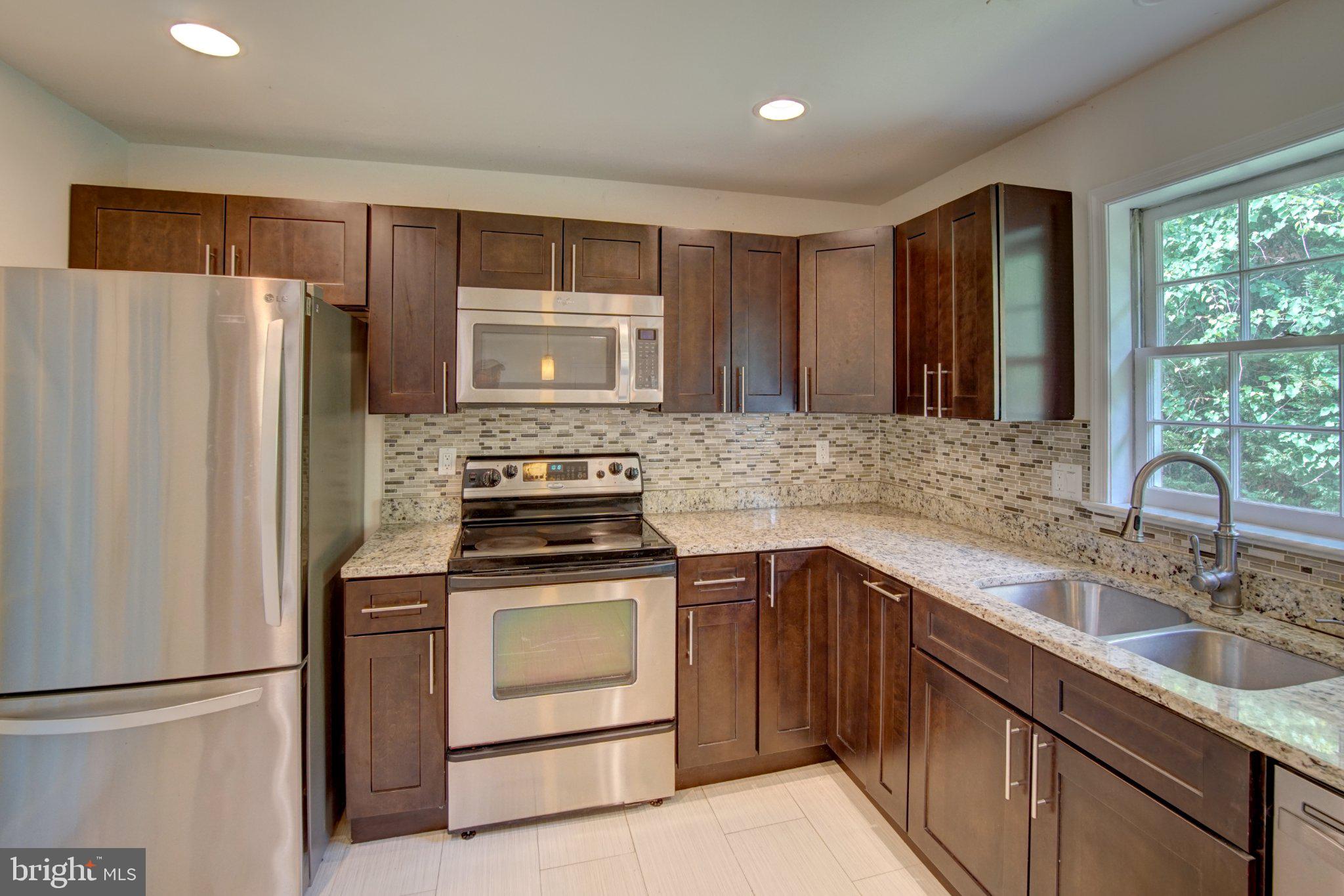 900 Walker Road Great Falls, VA 22066 - Photo 14 of 52 Modern kitchen with sleek finishes.