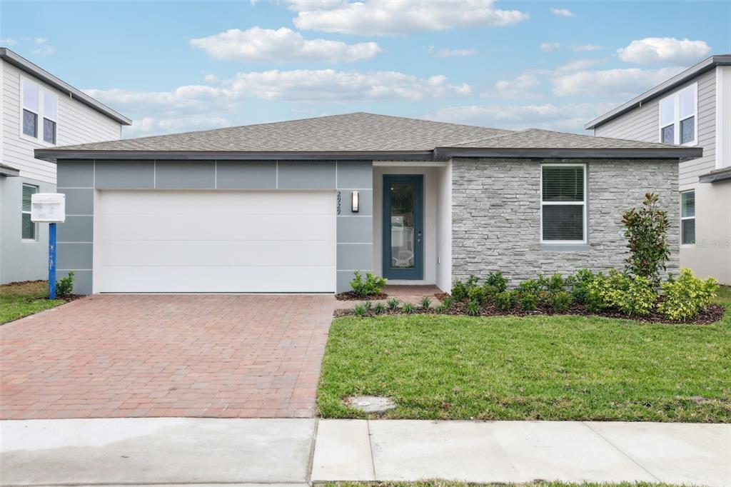 2929 Wild Olive Drive St. Cloud, FL 34772 - Photo 1 of 1 a picture of a house with a yard and garage