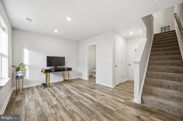 a view of a livingroom with wooden floor and furniture