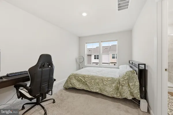 a bedroom with a bed and a desk