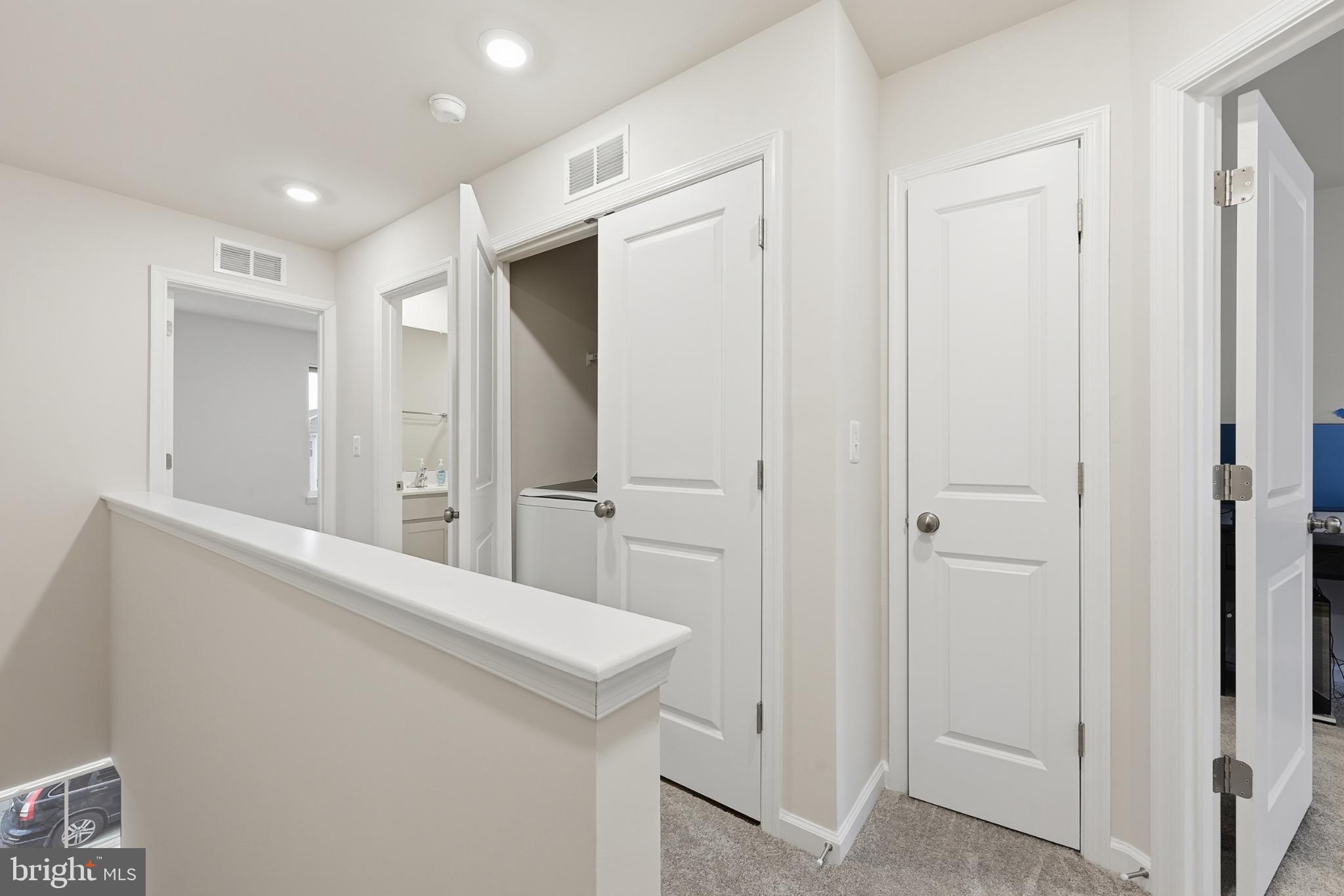 336 Mineral Springs Road Ranson, WV 25438 - Photo 31 of 38 Modern hallway with sleek doors and light.