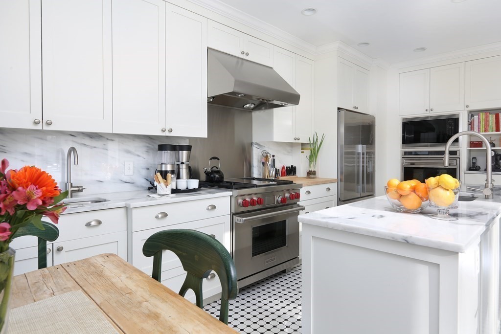 40 Windsor Road Newton, MA 02468 - Photo 11 of 29 a kitchen with stainless steel appliances granite countertop a sink a stove and a refrigerator
