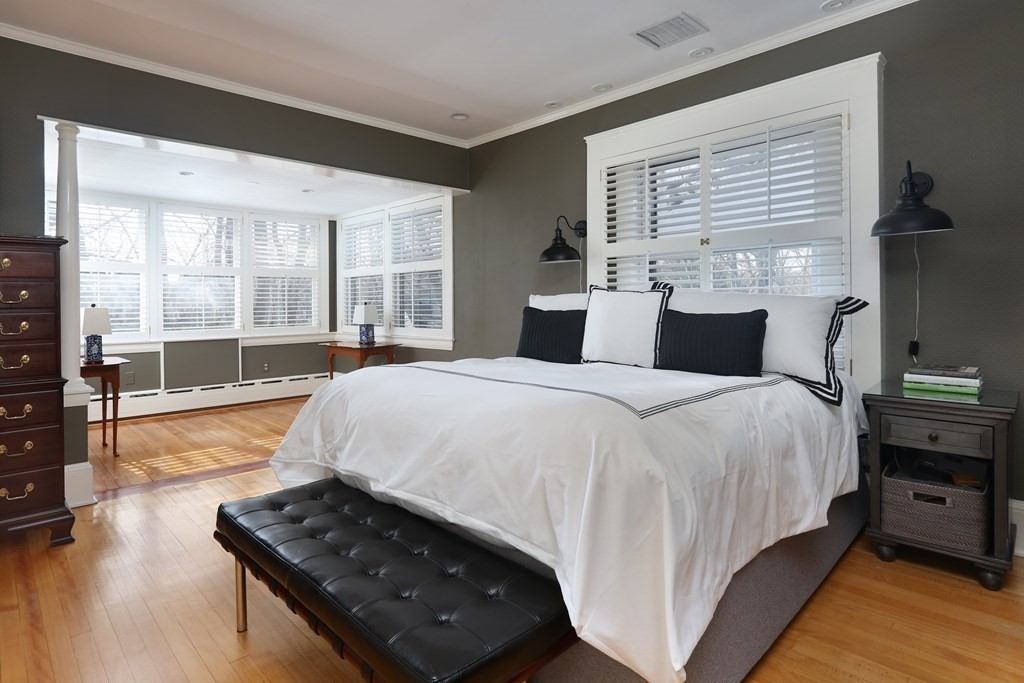 40 Windsor Road Newton, MA 02468 - Photo 16 of 29 a large bed sitting in a bedroom next to a window with a dresser