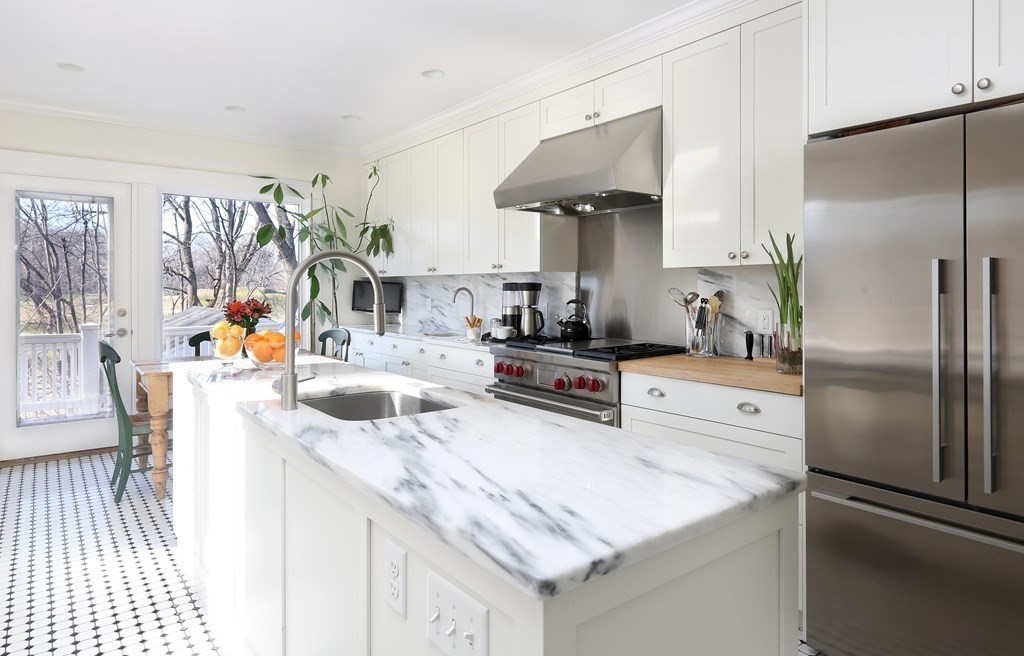 40 Windsor Road Newton, MA 02468 - Photo 9 of 29 a kitchen with stainless steel appliances granite countertop a sink and a refrigerator
