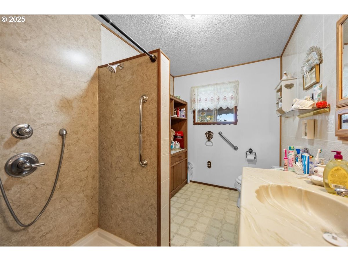 3620 Happy Valley Road Roseburg, OR 97471 - Photo 12 of 25 a bathroom with a tub sink and mirror