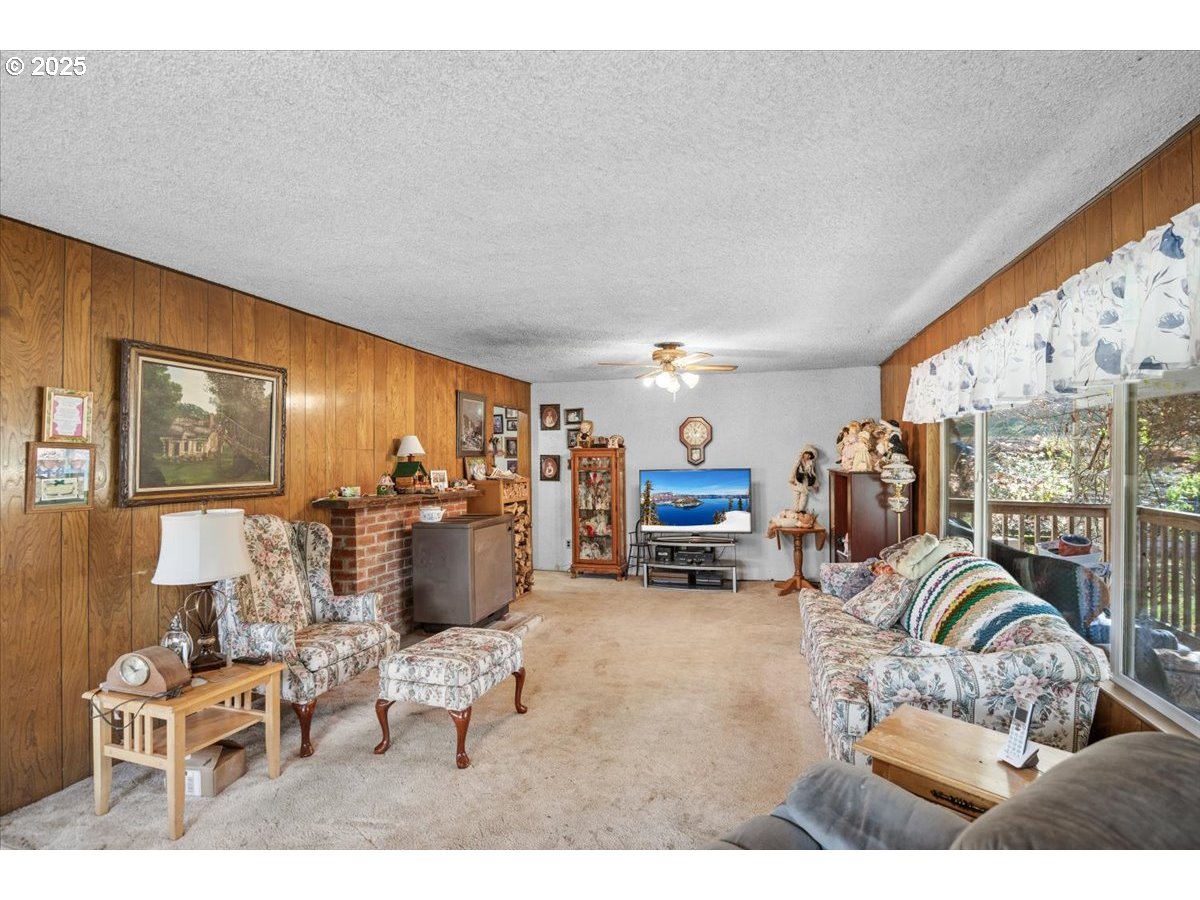 3620 Happy Valley Road Roseburg, OR 97471 - Photo 5 of 25 a living room with furniture a flat screen tv and a large window