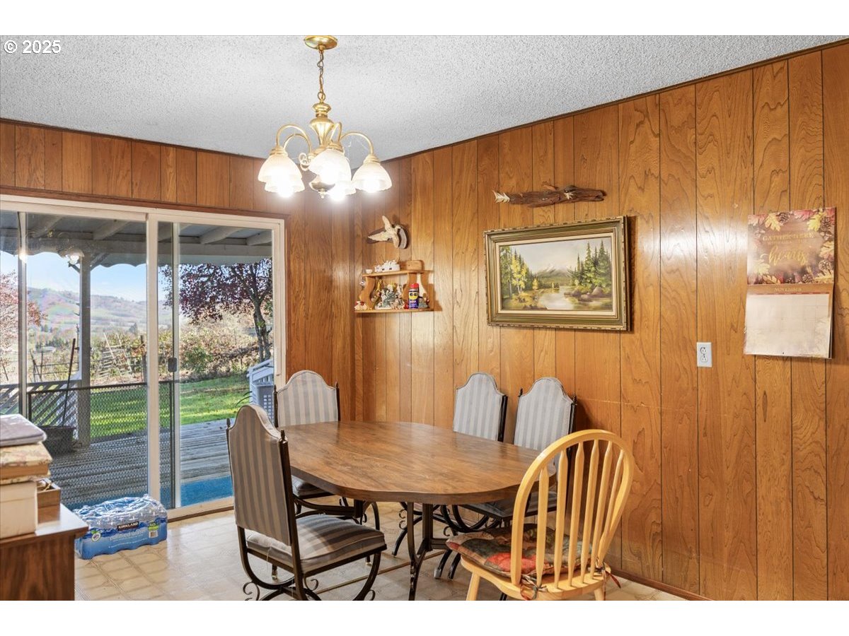 3620 Happy Valley Road Roseburg, OR 97471 - Photo 6 of 25 a view of a dining room with furniture wooden floor and chandelier