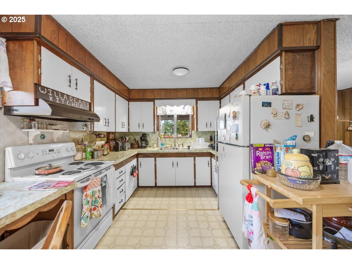 3620 Happy Valley Road Roseburg, OR 97471 - Photo 7 of 25 a kitchen with stainless steel appliances granite countertop a stove a sink dishwasher and cabinets with wooden floor