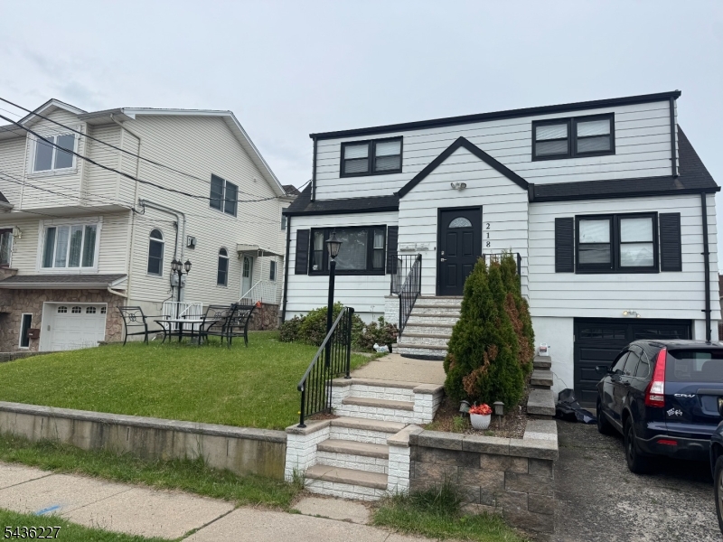 218 Bell Avenue Lodi, NJ 07644 - Photo 2 of 14 a front view of a house with a yard