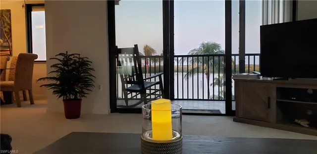 a view of a balcony with swimming pool and furniture