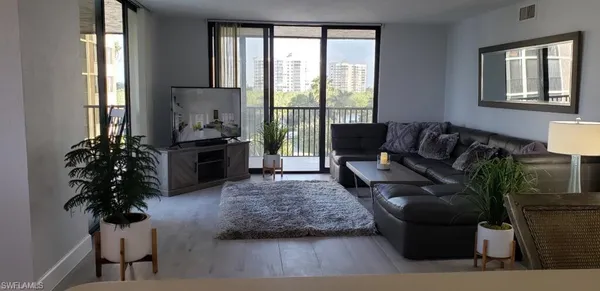 a living room with furniture and a large window