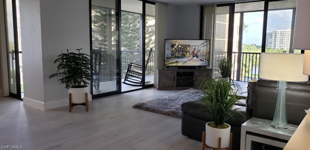 15 Bluebill Avenue, Unit 406 Naples, FL 34108 - Photo 3 of 18 a living room with furniture and a flat screen tv