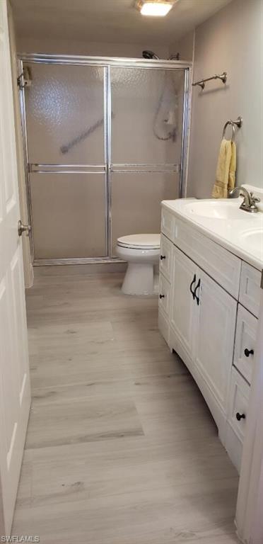 15 Bluebill Avenue, Unit 406 Naples, FL 34108 - Photo 8 of 18 a bathroom with a sink a toilet and shower
