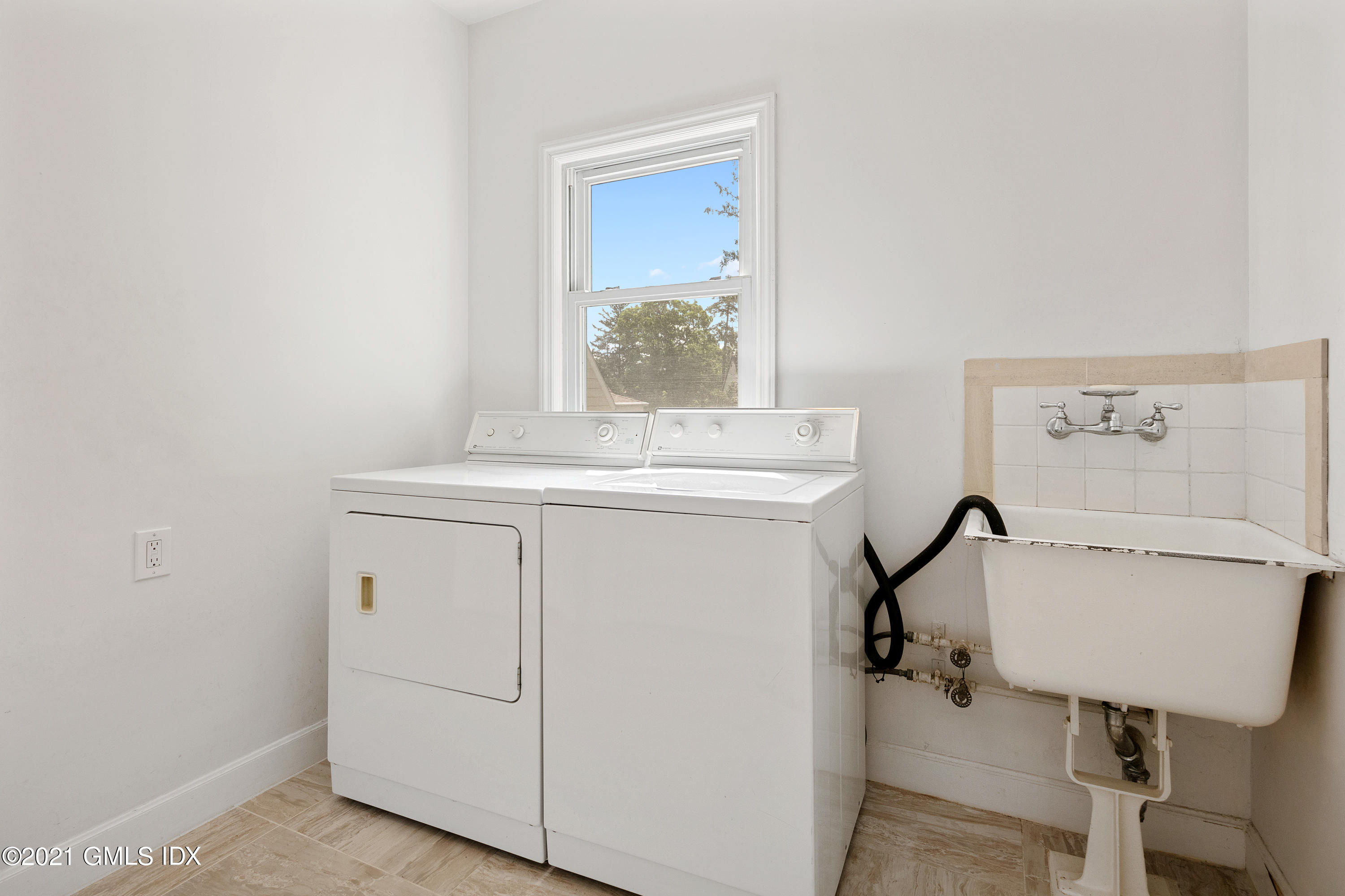 14 Byram Shore Road Greenwich, CT 06830 - Photo 28 of 47 a utility room with dryer washer and sink