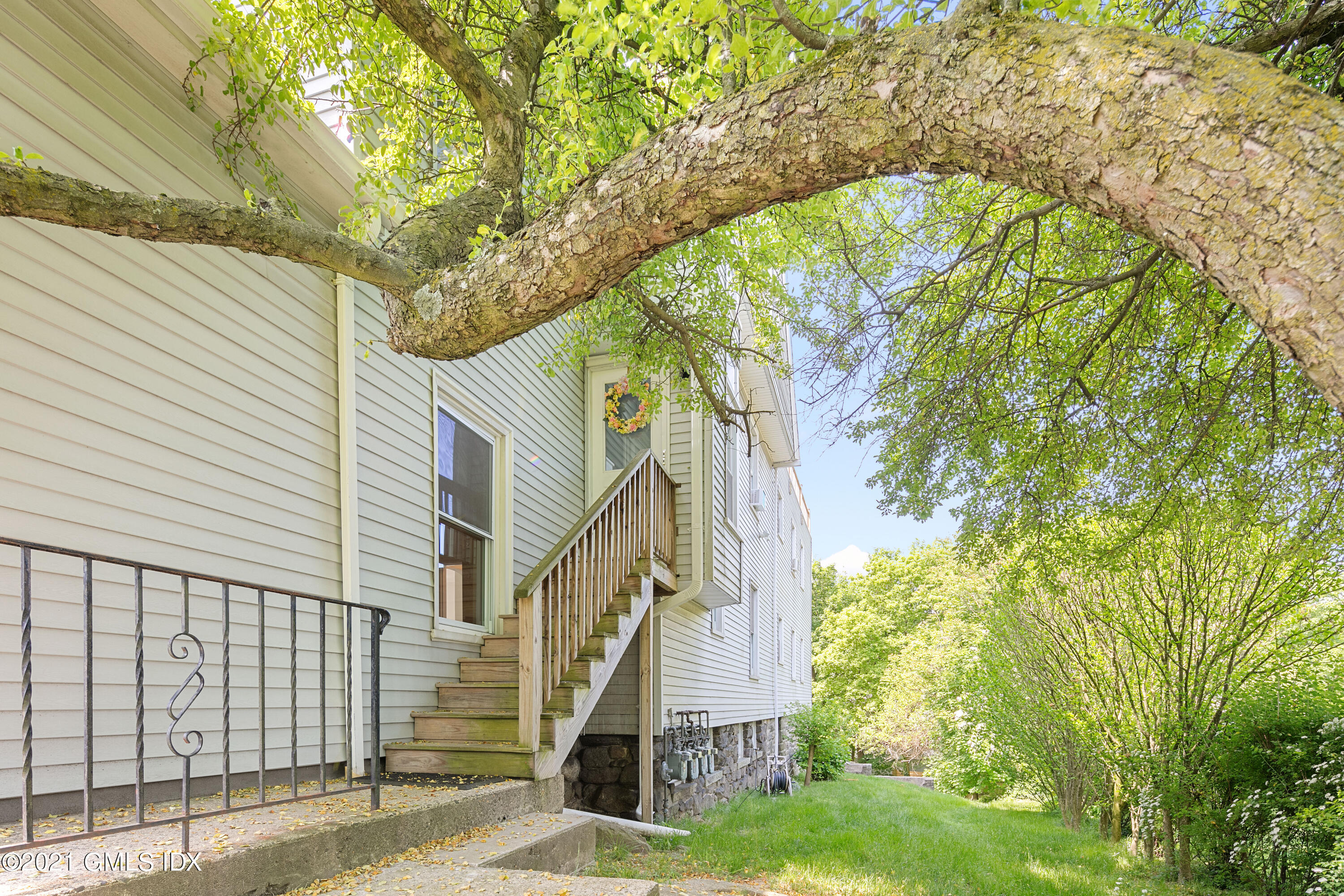 14 Byram Shore Road Greenwich, CT 06830 - Photo 32 of 47 a view of a house with a tree