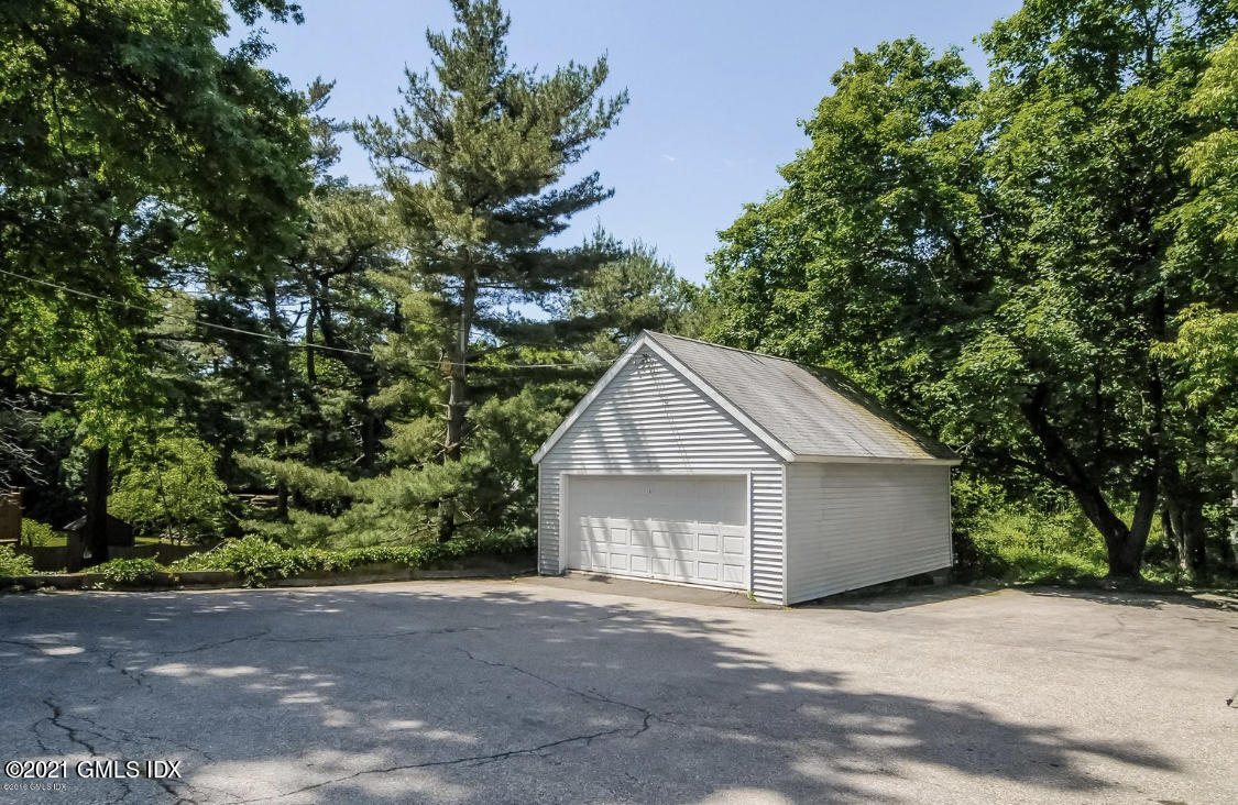 14 Byram Shore Road Greenwich, CT 06830 - Photo 41 of 47 a front view of a house with a yard and garage