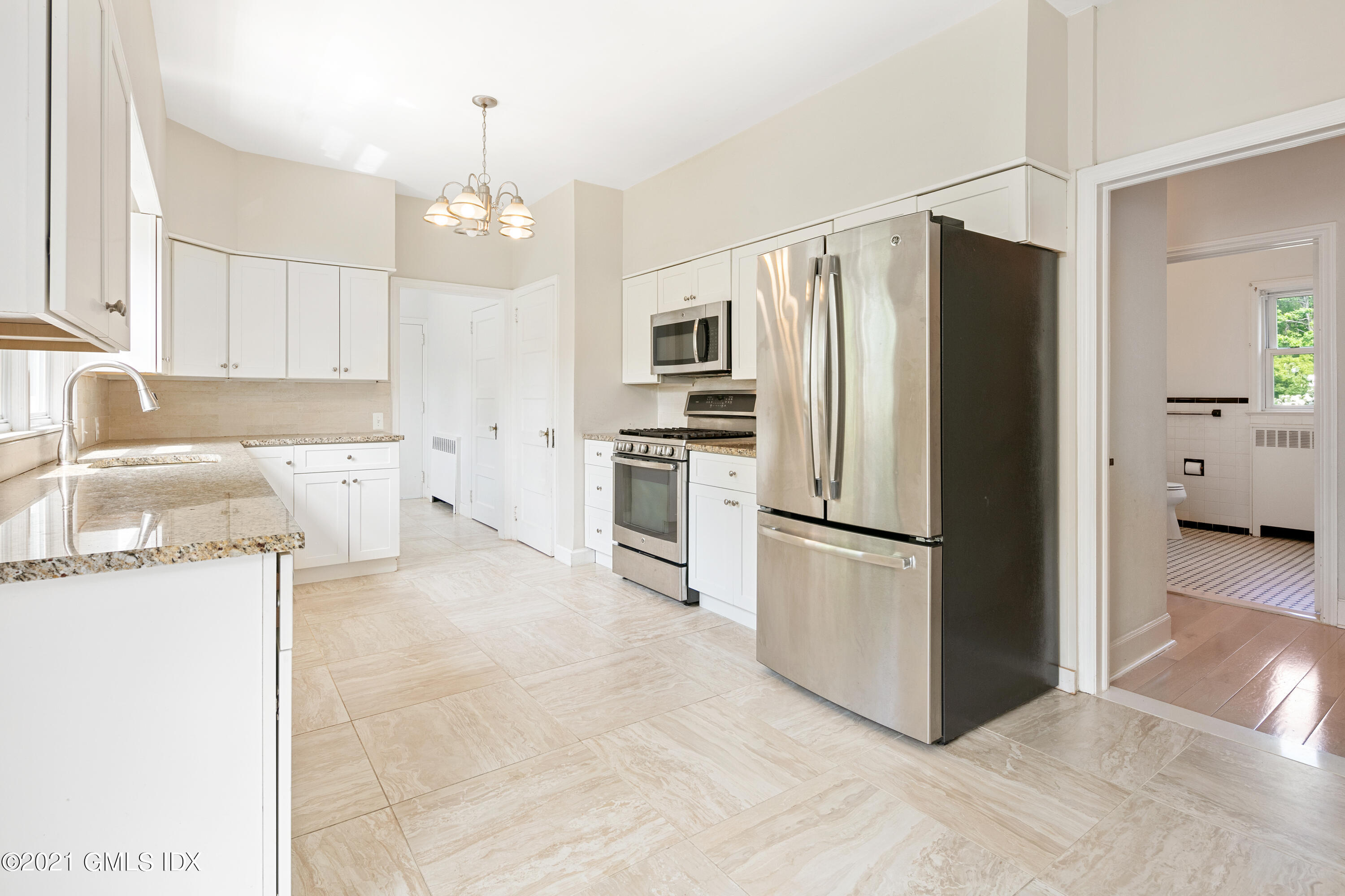 14 Byram Shore Road Greenwich, CT 06830 - Photo 6 of 47 a kitchen with stainless steel appliances granite countertop a refrigerator a sink a stove and white cabinets