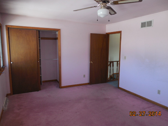 774 Lake Road New Lenox, IL 60451 - Photo 12 of 14 an empty room with a ceiling fan and carpet