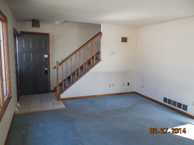 774 Lake Road New Lenox, IL 60451 - Photo 3 of 14 a view of a room with wooden floor and stairs