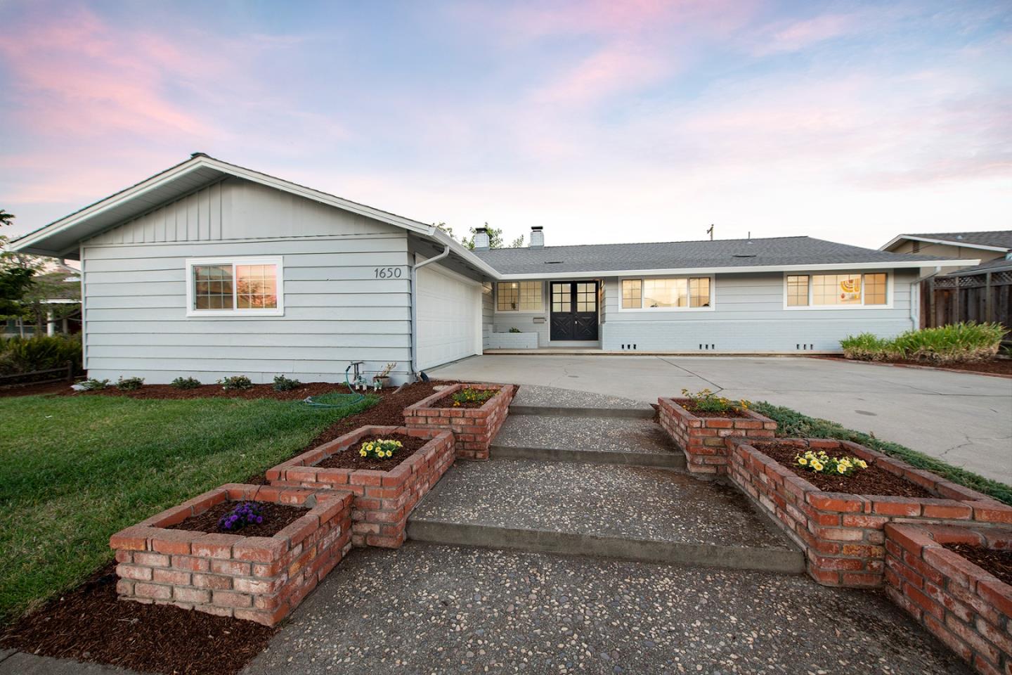 1650 Manitoba Drive Sunnyvale, CA 94087 - Photo 2 of 26 a front view of a house with a garden