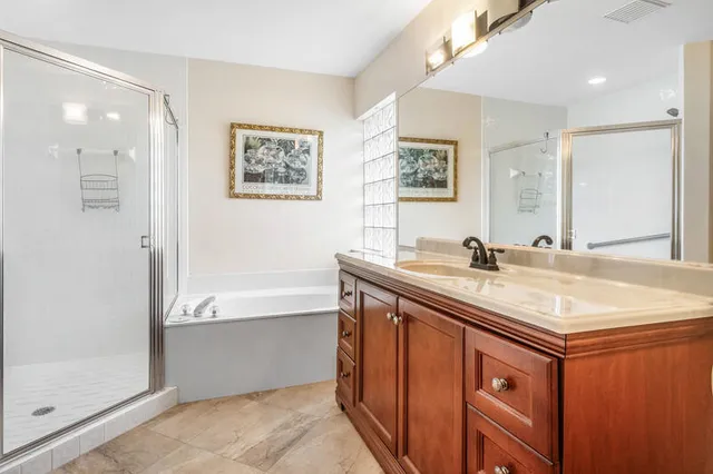 a bathroom with a sink double vanity and a bathtub
