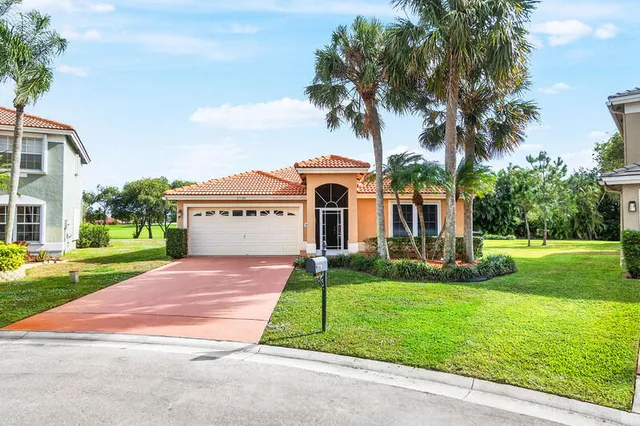 a view of a house with a yard and a garden